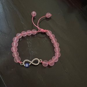 This is a pink evil eye adjustable bracelet.